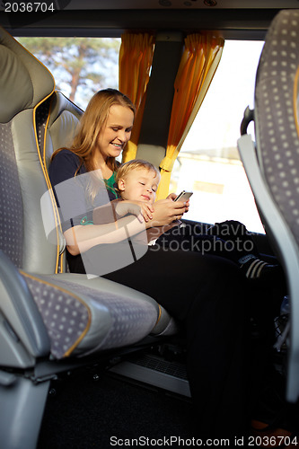 Image of Mother and kid are playing game on the phone.