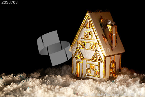 Image of Little toy house covered with artificial snow.