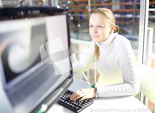 Image of Young girl is choosing the notebook.