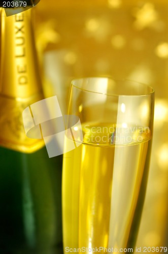 Image of Flute glass and a bottle of Champagne