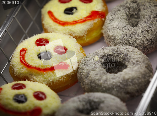 Image of Doughnuts on a shelf of pastry shop