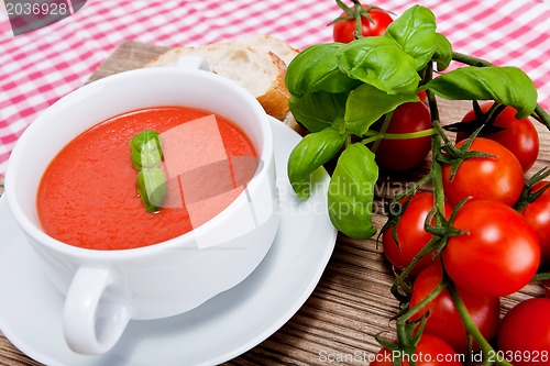 Image of tasty fresh tomato soup basil and bread