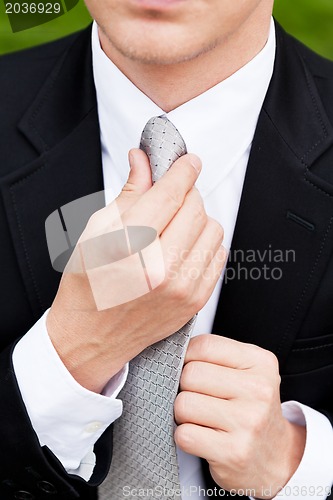 Image of business man with black suit and tie outdoor