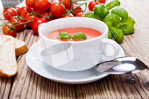 Image of tasty fresh tomato soup basil and bread