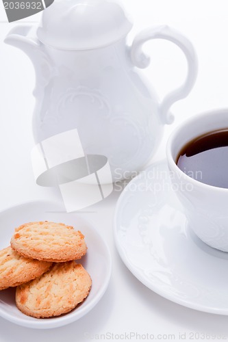 Image of dark coffee in cup homemade cookie on table