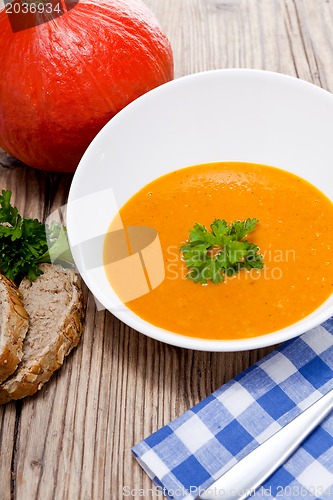 Image of fresh tasty pumpkin soup and bread