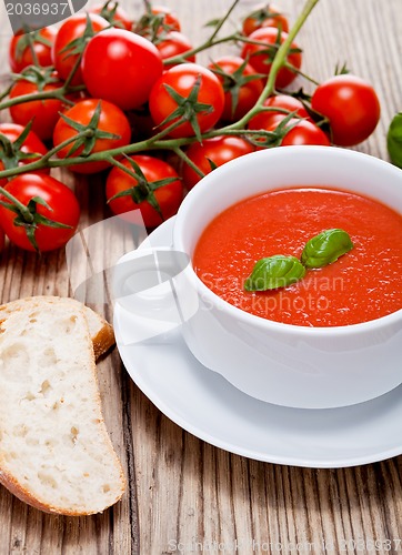 Image of tasty fresh tomato soup basil and bread