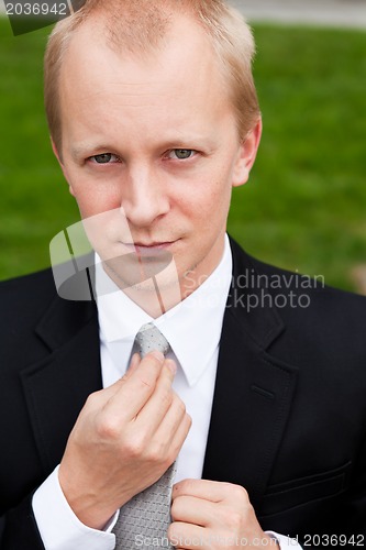 Image of business man with black suit and tie outdoor