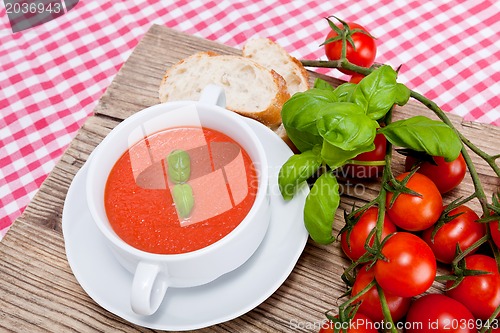 Image of tasty fresh tomato soup basil and bread