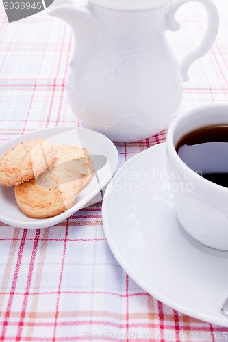 Image of dark coffee in cup homemade cookie on table