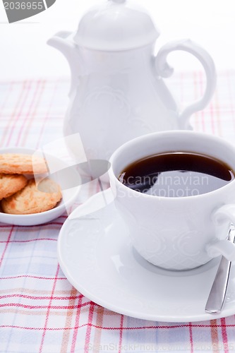 Image of dark coffee in cup homemade cookie on table