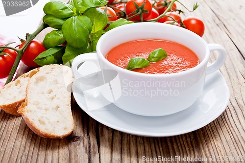 Image of tasty fresh tomato soup basil and bread