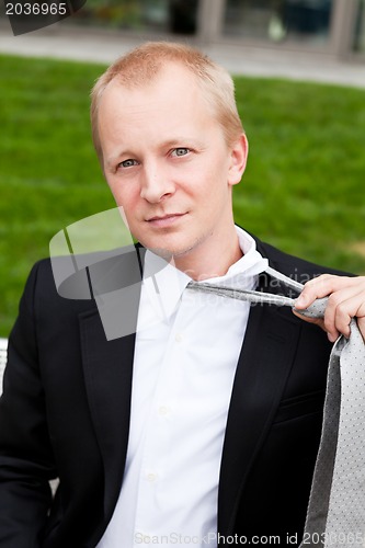 Image of business man with black suit and tie outdoor