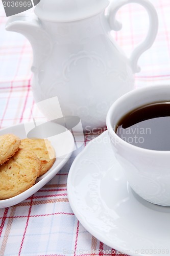 Image of dark coffee in cup homemade cookie on table