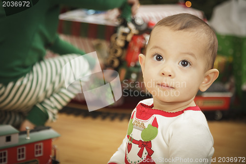 Image of Infant Baby Enjoying Christmas Morning Near The Tree