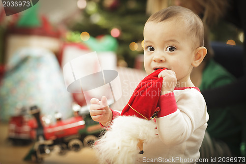 Image of Infant Baby Enjoying Christmas Morning Near The Tree