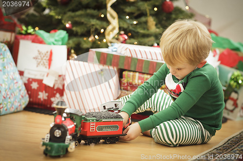 Image of Young Boy Enjoying Christmas Morning Near The Tree