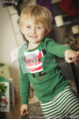 Image of Young Boy Enjoying Christmas Morning Near The Tree