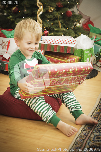 Image of Young Boy Enjoying Christmas Morning Near The Tree