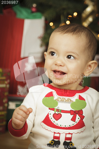 Image of Infant Baby Enjoying Christmas Morning Near The Tree