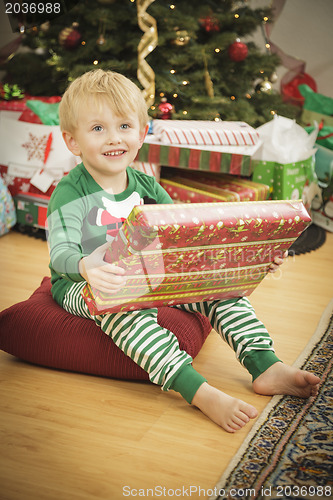 Image of Young Boy Enjoying Christmas Morning Near The Tree