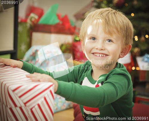 Image of Young Boy Enjoying Christmas Morning Near The Tree