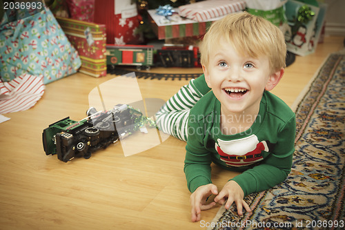 Image of Young Boy Enjoying Christmas Morning Near The Tree