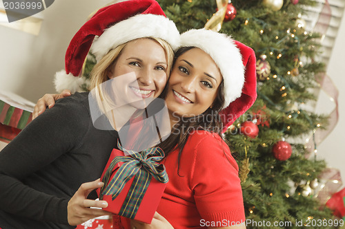 Image of Young Mixed Race Girlfriends with Christmas Gift