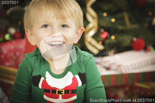 Image of Young Boy Enjoying Christmas Morning Near The Tree