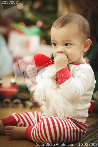 Image of Infant Baby Enjoying Christmas Morning Near The Tree