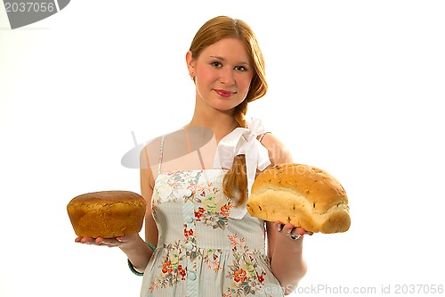 Image of A young girl with fresh bread in the hands of