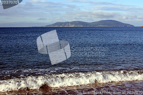 Image of Sea landscape. Waves of sea of Japan and island in a distance. Russia