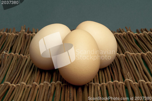 Image of Raw eggs on wooden base