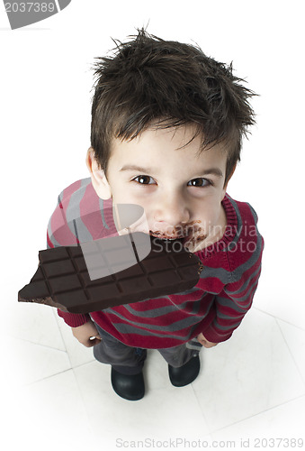 Image of Smiling little boy eating chocolate