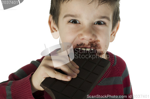 Image of Smiling little boy eating chocolate