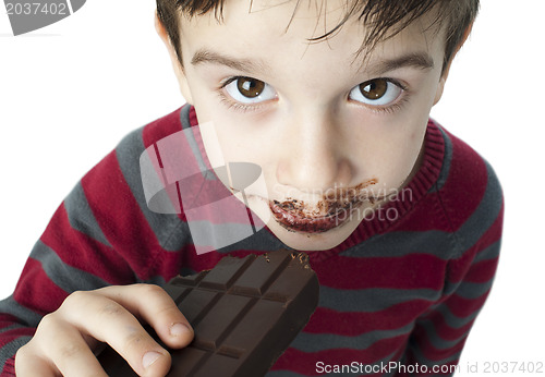 Image of Smiling little boy eating chocolate