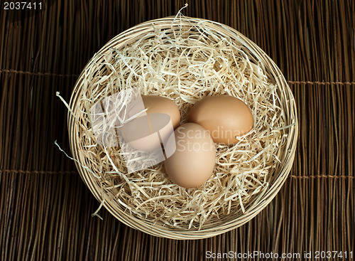 Image of Raw eggs in a wicker basket