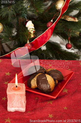 Image of Christmas sweets and candle on the table