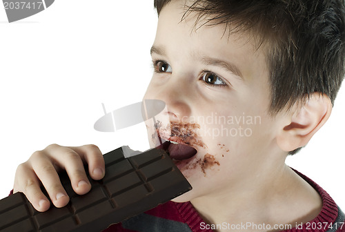 Image of Smiling little boy eating chocolate