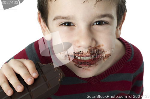 Image of Smiling little boy eating chocolate