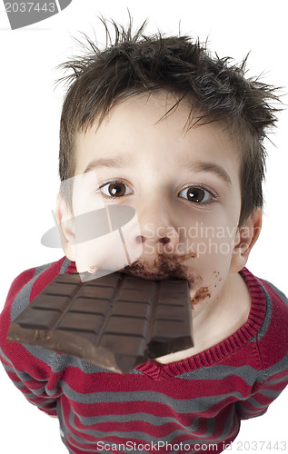 Image of Smiling little boy eating chocolate