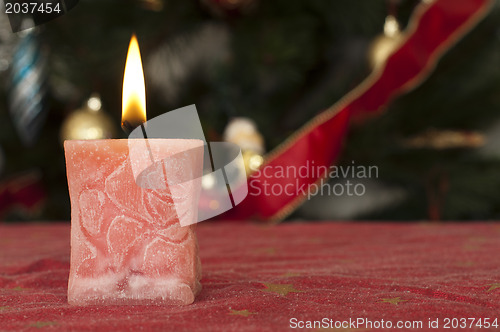 Image of Christmas candle on the festive table