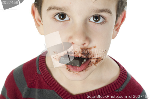 Image of Smiling little boy eating chocolate