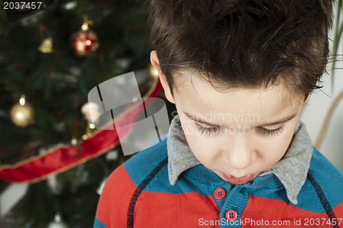 Image of Unhappy little boy on christmass