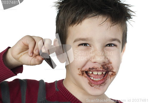 Image of Smiling little boy eating chocolate