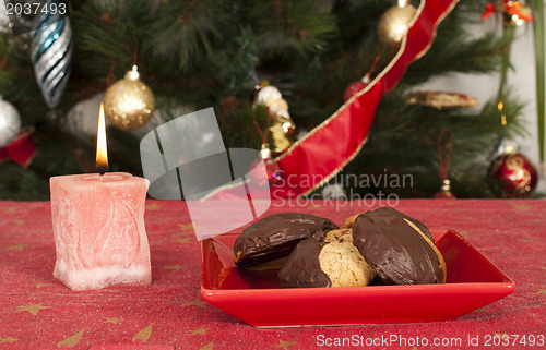 Image of Christmas sweets and candle on the table