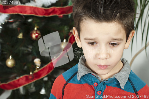 Image of Unhappy little boy on christmass