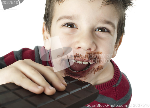 Image of Smiling little boy eating chocolate