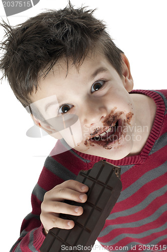 Image of Smiling little boy eating chocolate