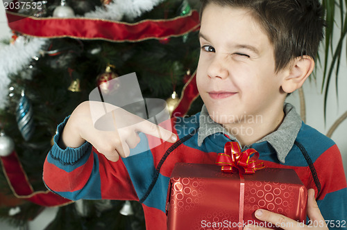 Image of Boy points out his gift on Christmas